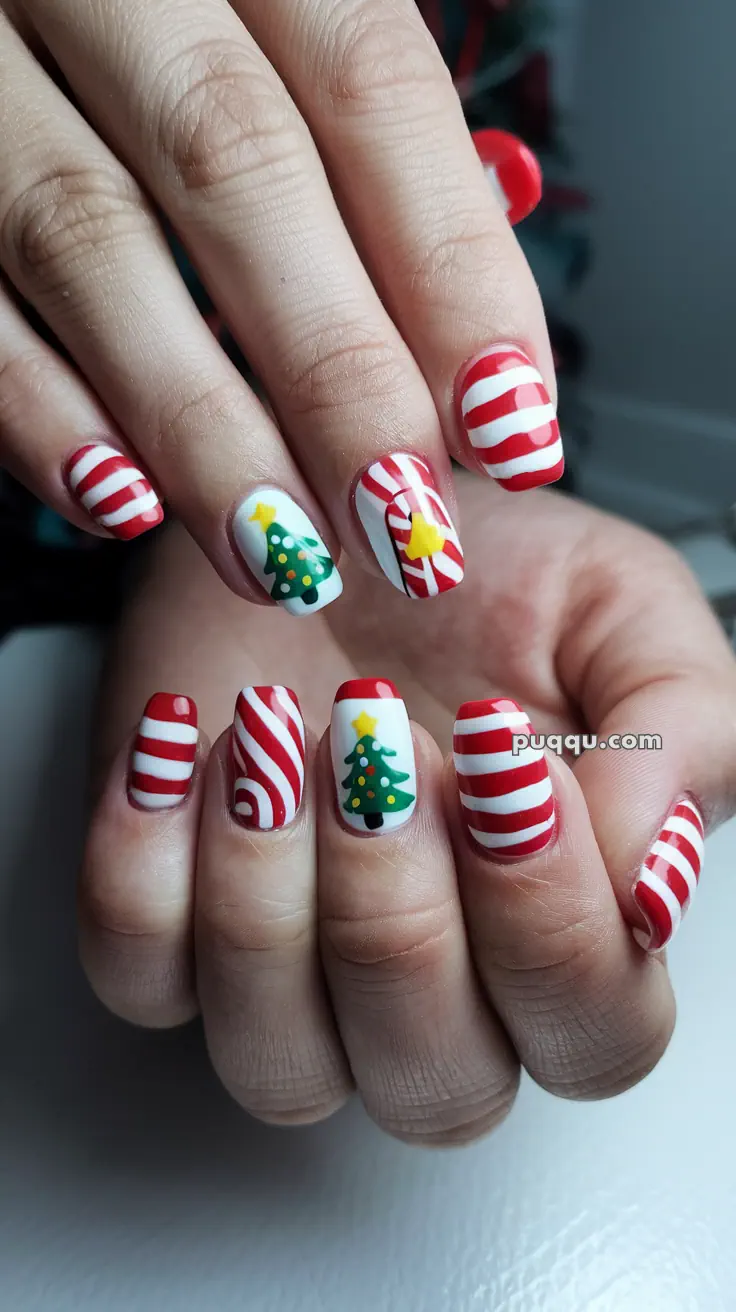 Red and white striped nails with Christmas tree designs on several fingers.