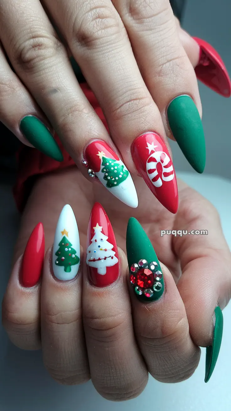 Festive Christmas-themed nail art featuring red, green, and white colors with designs of Christmas trees, candy canes, and rhinestone embellishments.