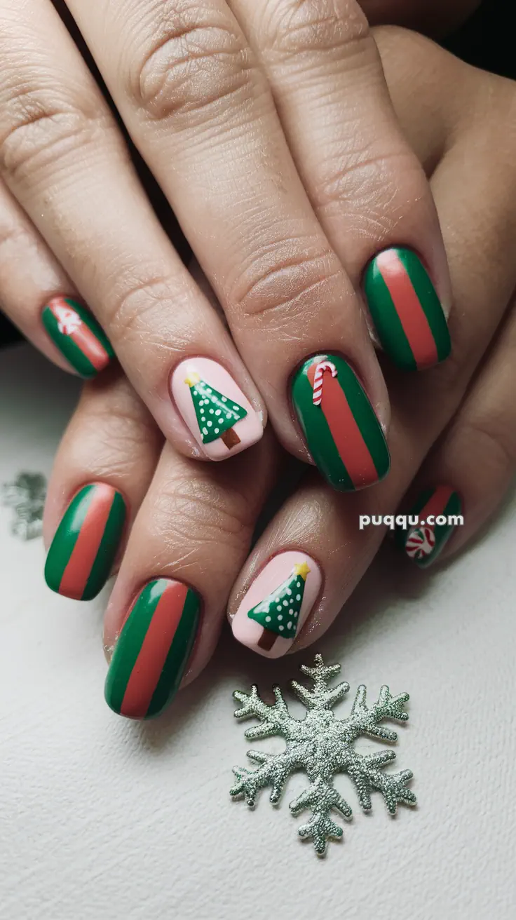 Festive Christmas-themed nail art with green and red stripes, decorated with Christmas trees and candy cane designs.