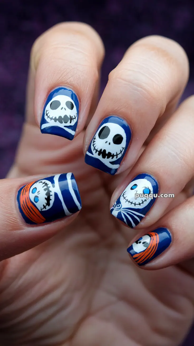 Nails with blue and white skull-themed designs.