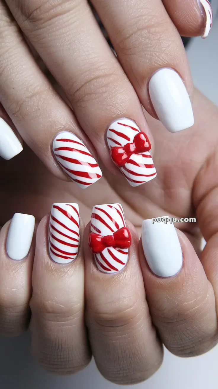 White nails with red stripes and 3D red bows.