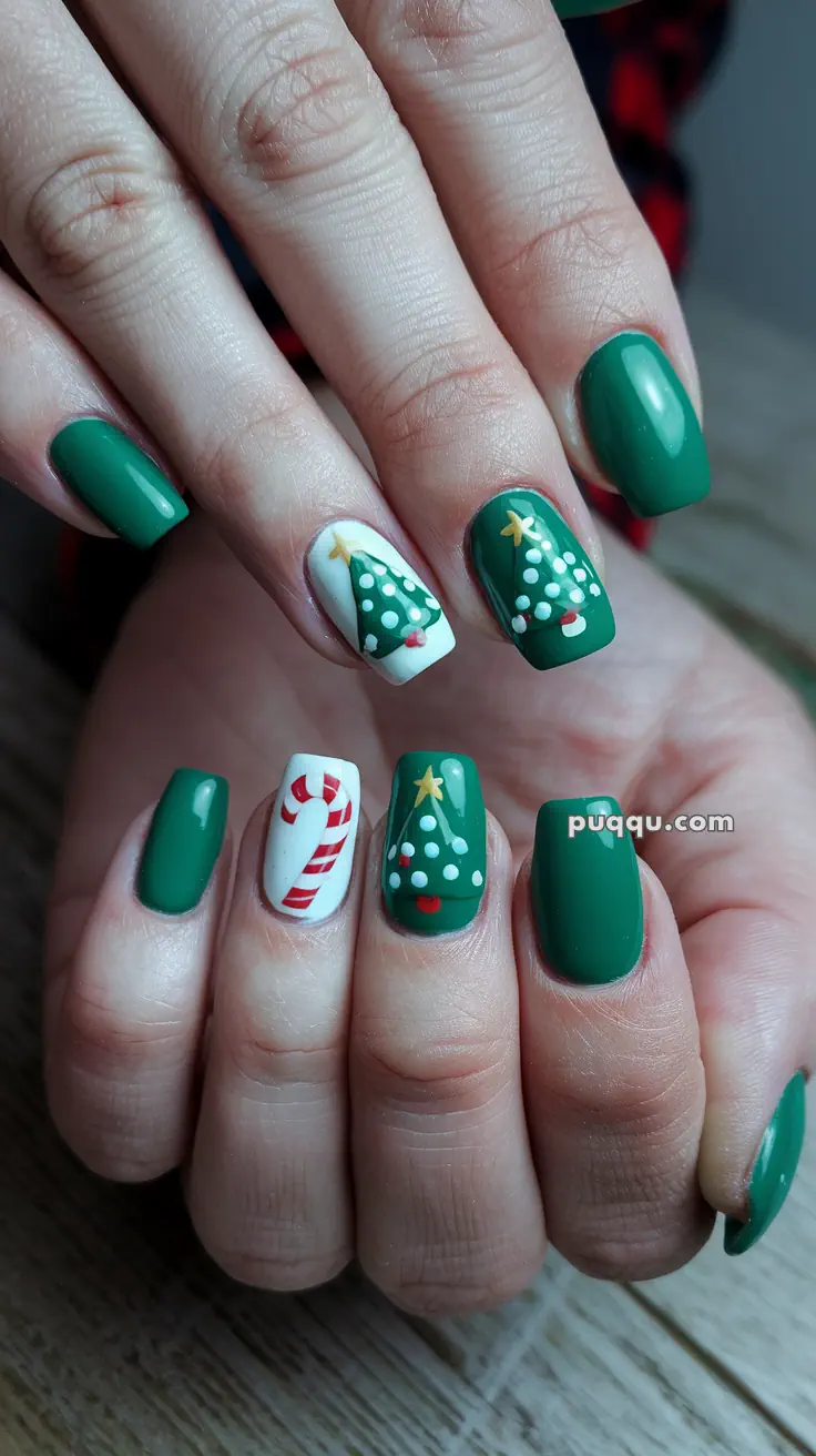 Green and white Christmas-themed nail art featuring Christmas trees and a candy cane design.