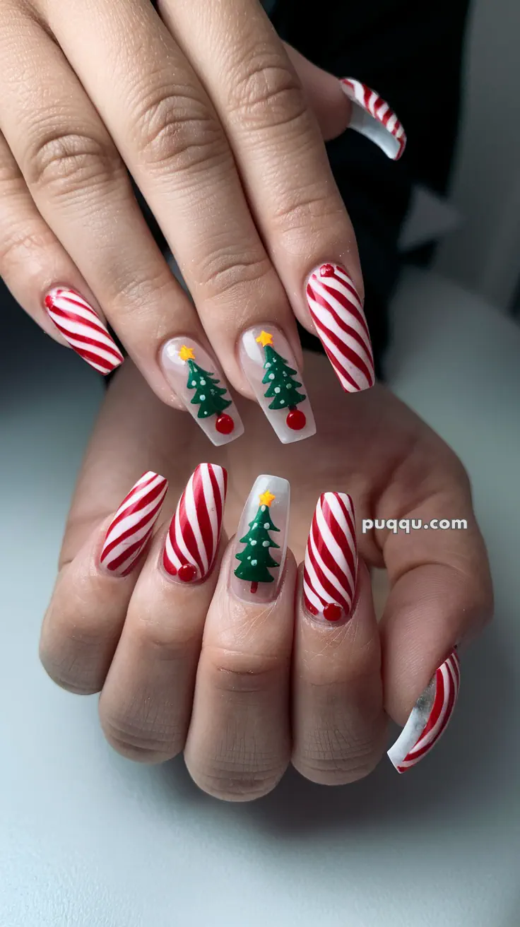 Fingernails with red and white candy cane stripes and Christmas tree designs.