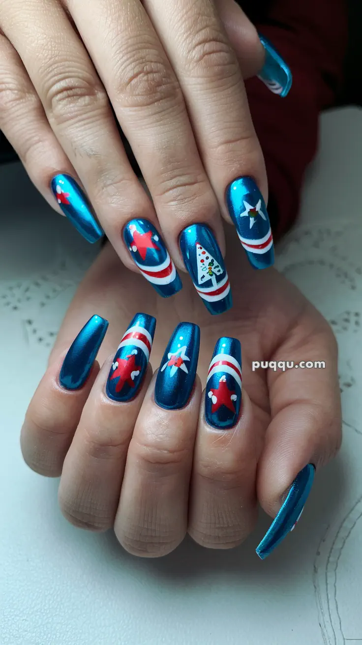 Blue nails with festive holiday designs, including stars and trees, accented with red and white details.