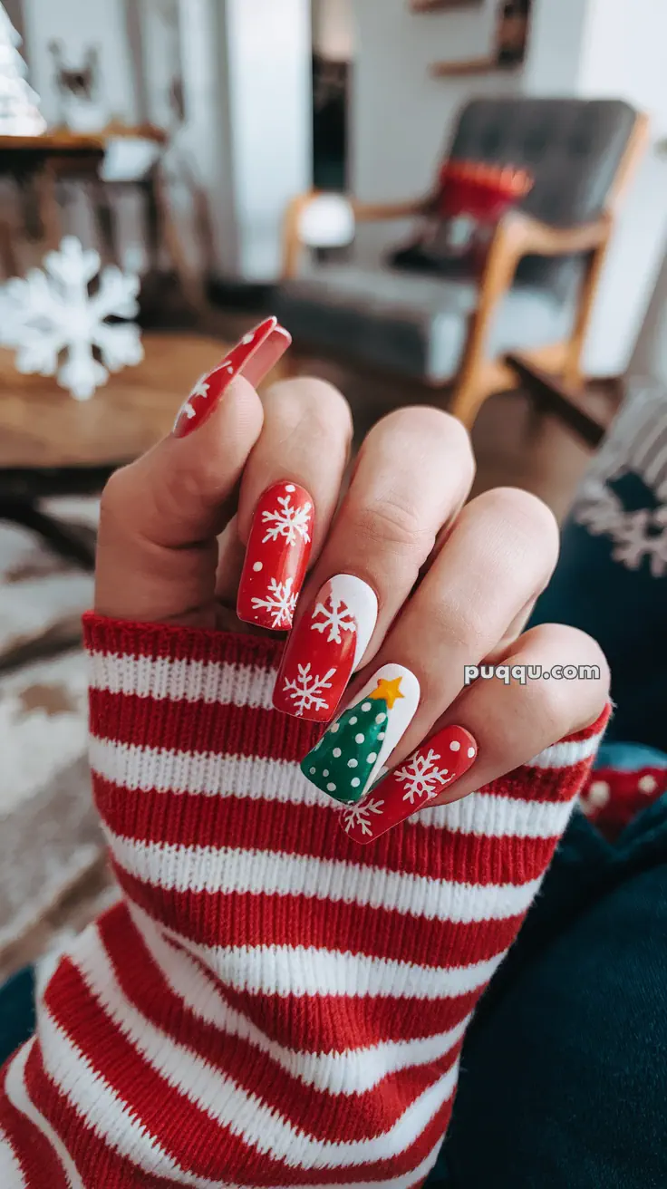 Festive Christmas-themed nails with red polish, white snowflakes, and a green Christmas tree design.