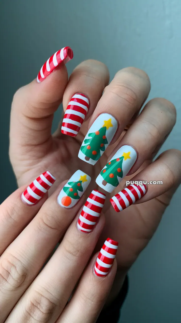 Fingernails painted with Christmas-themed designs: red and white stripes, and green Christmas trees with stars and dots.