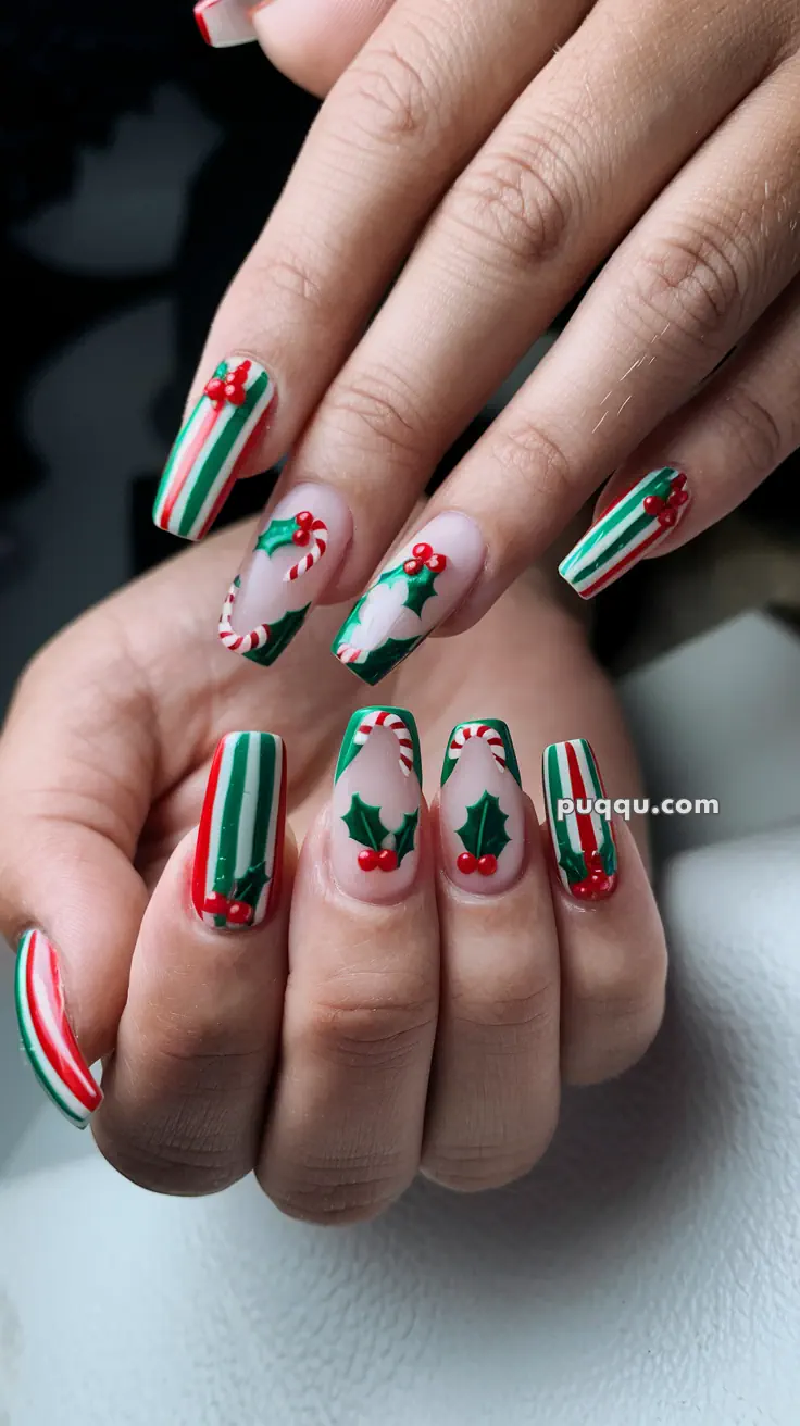 Festive Christmas-themed nail art with candy cane stripes, holly leaves, and berries.