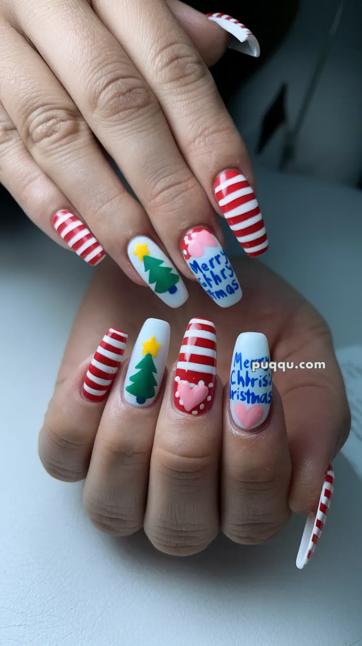 Close-up of festive Christmas-themed nail art featuring red and white stripes, Christmas trees, a pink heart, and the phrase "Merry Christmas" in blue.