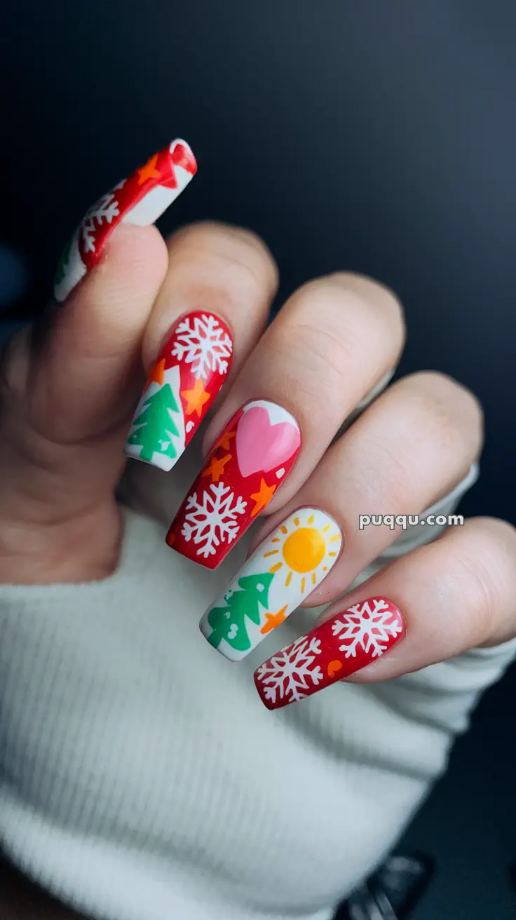 Festive nail art with red and white snowflakes, green trees, orange stars, a sun, and a pink heart design.