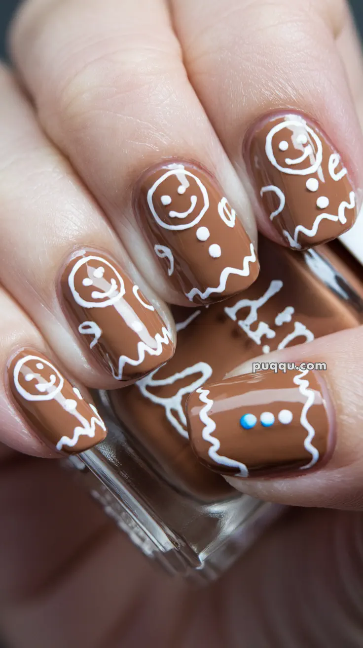 Brown nails with white gingerbread men designs.