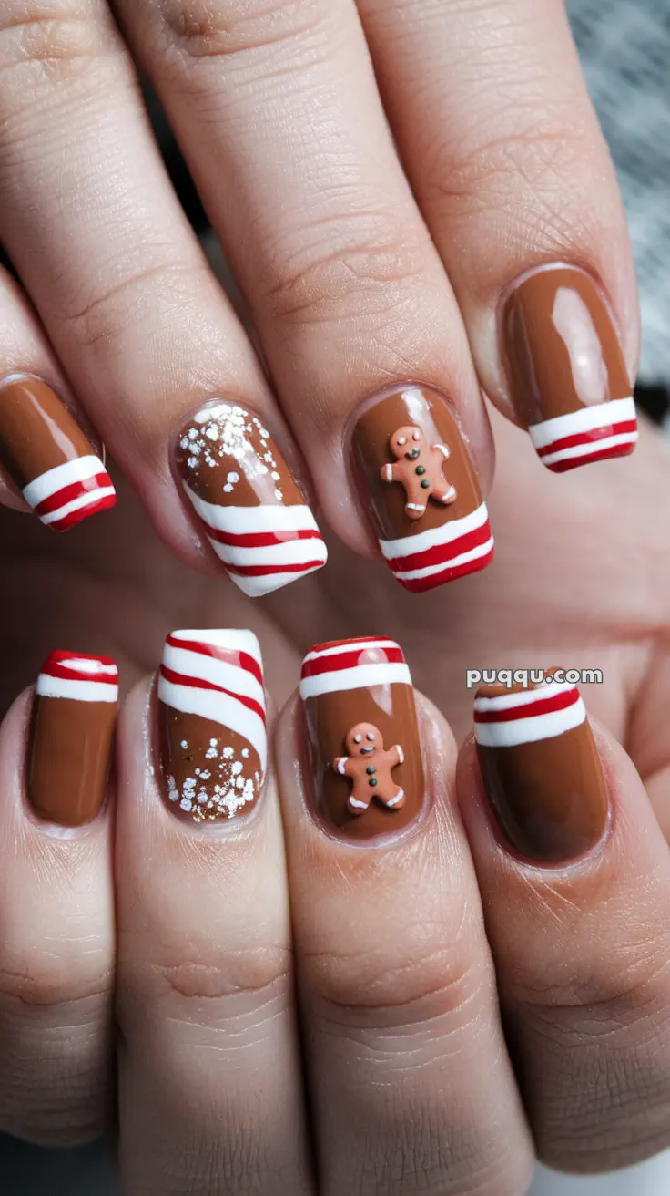 Brown and red themed nail art featuring gingerbread men and white snowflake accents.