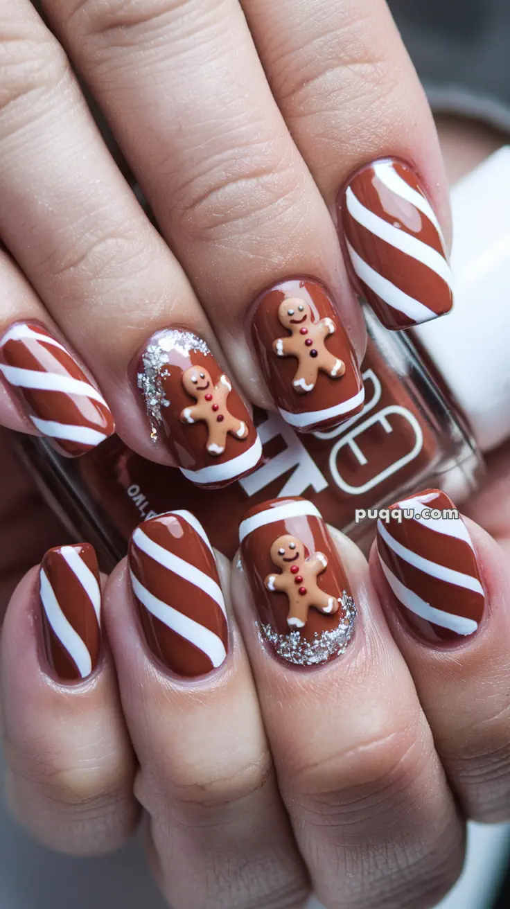 Nails with brown and white striped design and gingerbread man decorations.