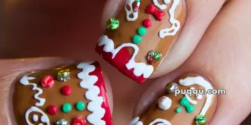 Close-up of festive nail art featuring gingerbread men designs with colorful accents and detailing.