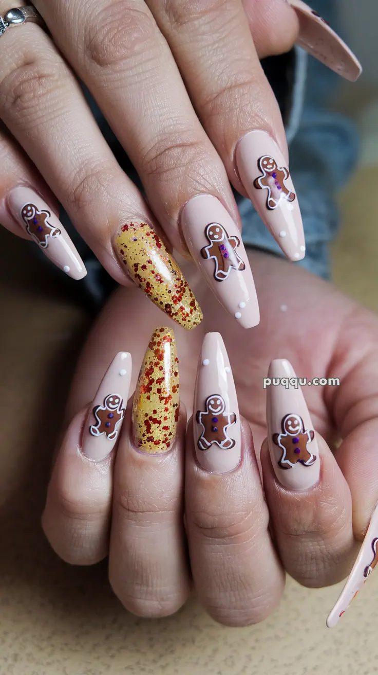 Nails with gingerbread man designs and one nail with gold glitter and red speckles.