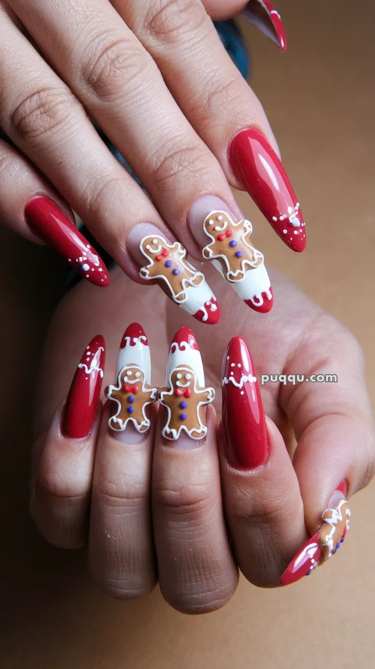 Long red nails with white icing designs and gingerbread men decorations.