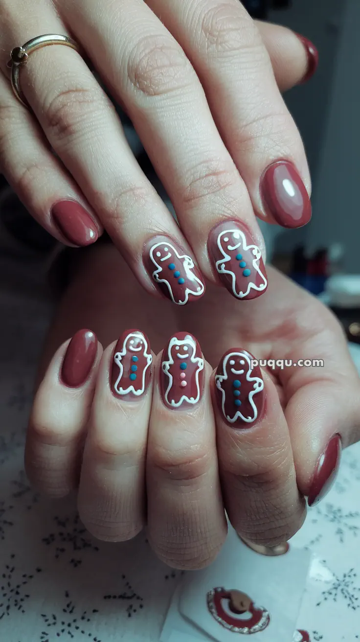 Nails painted with brown polish featuring gingerbread man designs outlined in white.