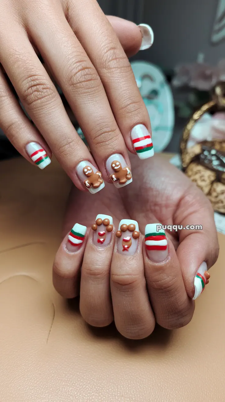 Festive nails with gingerbread men and red, green, white striped patterns.