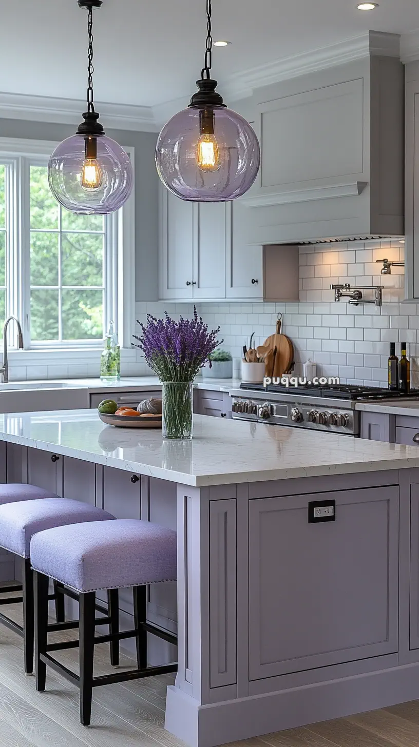 Modern kitchen with lavender cabinetry and island, white countertops, pendant lights, and a glass vase with lavender flowers.