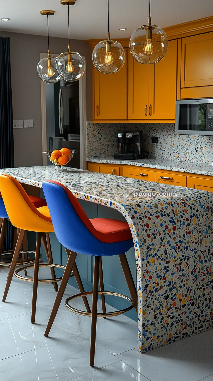 Colorful kitchen with yellow cabinets, a terrazzo countertop, vibrant chairs, and globe pendant lights.