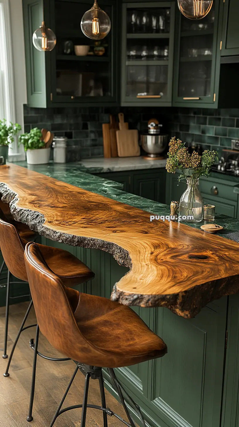 Kitchen with a live edge wooden countertop, green cabinets, brown leather barstools, and glass pendant lights.