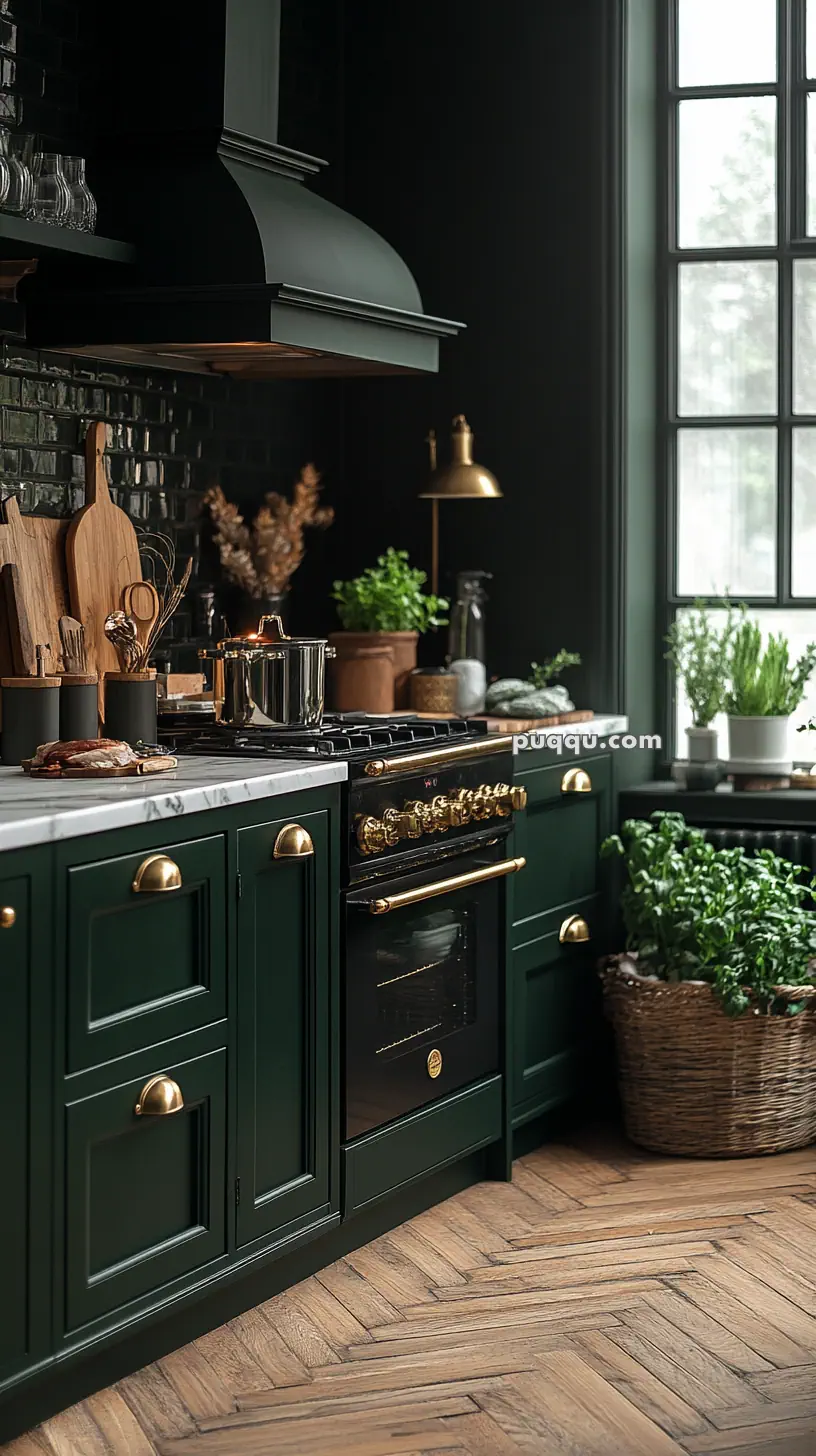 Stylish kitchen with dark green cabinets, gold handles, a marble countertop, and potted herbs near a large window, featuring a classic-style oven and brass accents.