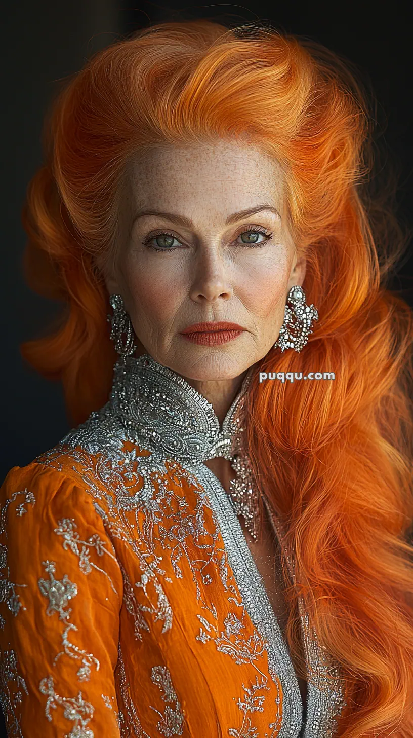 Elderly woman with vibrant orange hair and elaborate orange and silver embroidered attire.