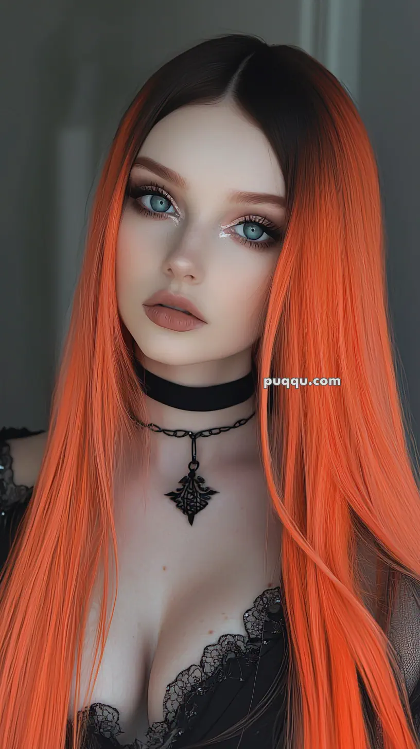 A person with long orange hair, wearing a black lace top and a choker necklace with a pendant.