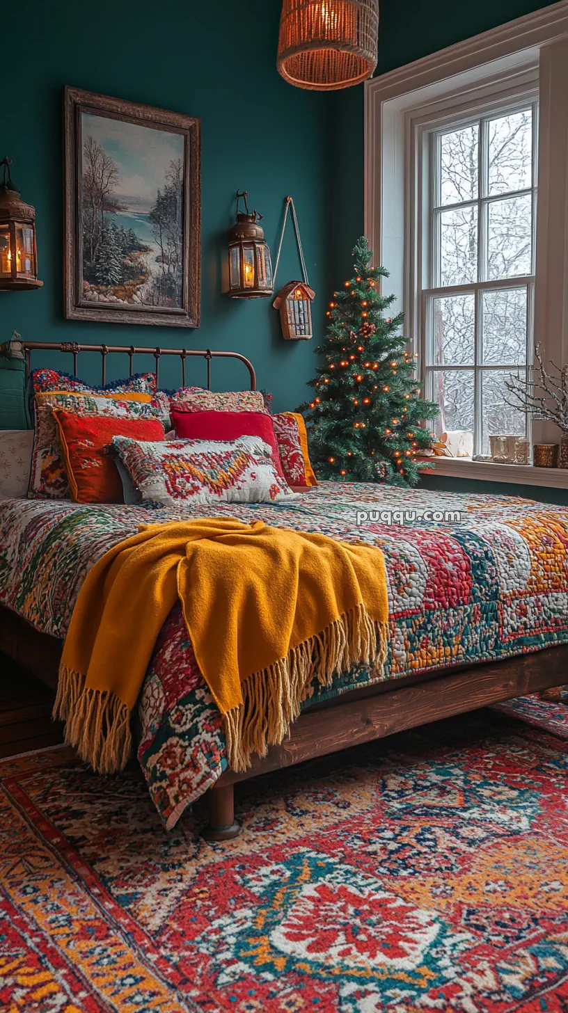 Cozy bedroom with colorful patchwork bedding, a mustard throw, a small decorated Christmas tree, and a large window showing a winter scene.