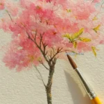 A watercolor painting of a cherry blossom tree with pink blooms, set against a light background, with a fine artist's paintbrush resting on the paper.