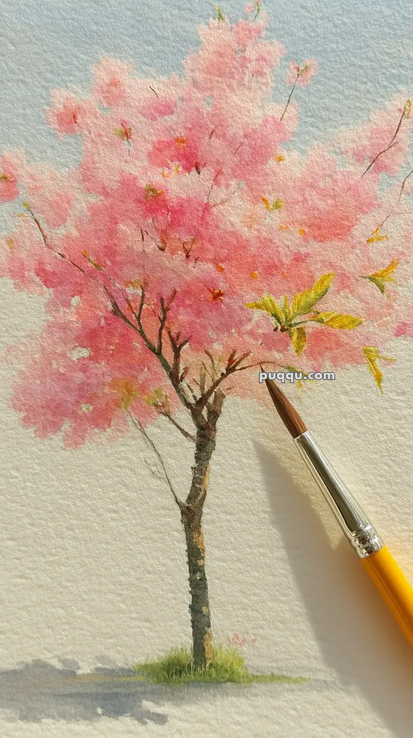 A watercolor painting of a cherry blossom tree with pink blooms, set against a light background, with a fine artist's paintbrush resting on the paper.