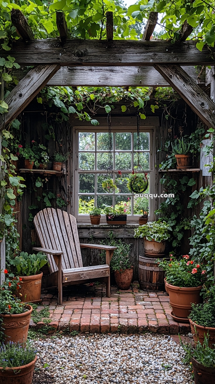 A cozy garden nook featuring a wooden chair surrounded by potted plants on brick and gravel flooring, underneath a wooden pergola covered with green foliage.