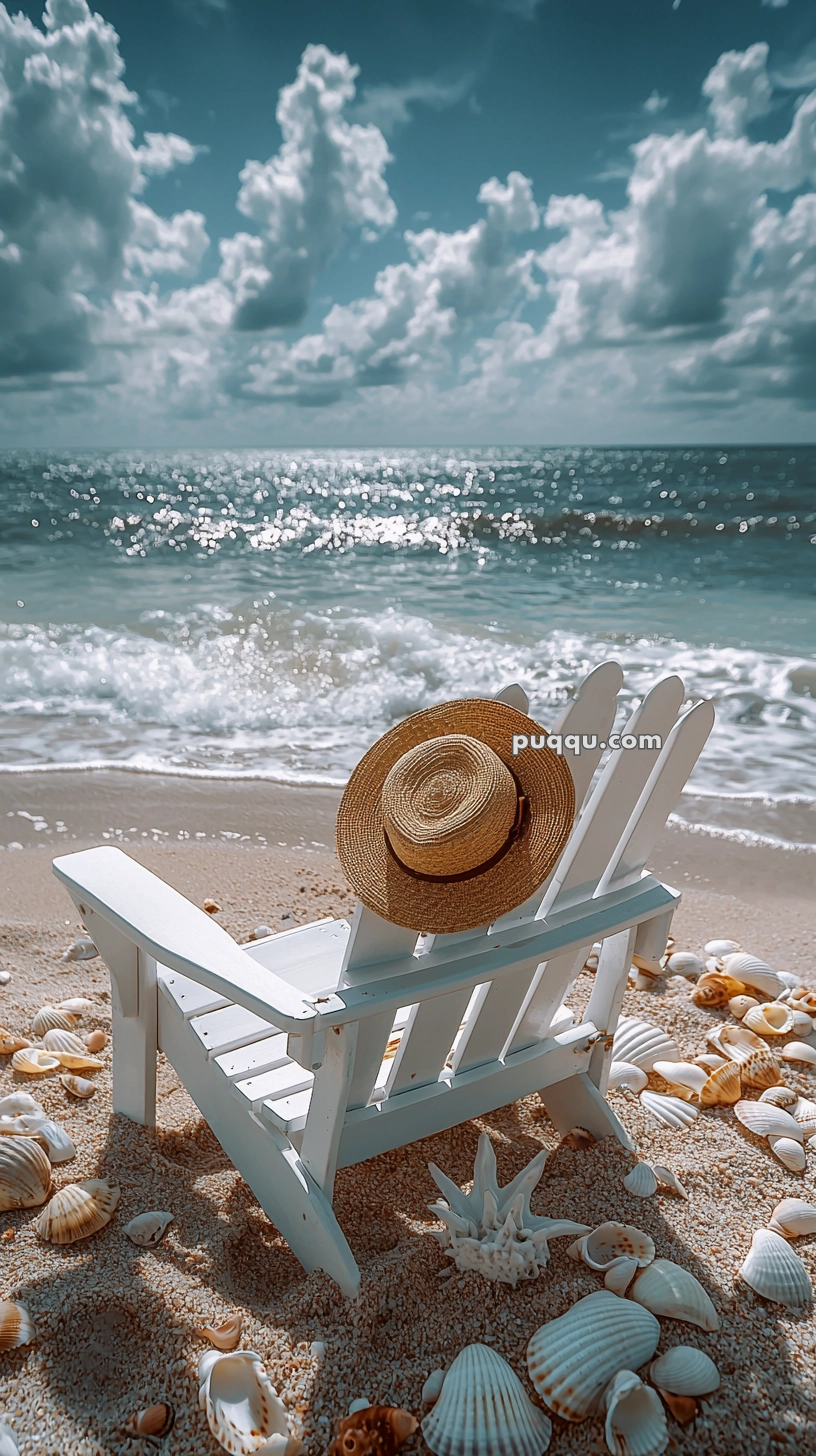 A straw hat resting on a white wooden beach chair, surrounded by seashells on a sandy beach with waves in the background and a cloudy sky overhead.