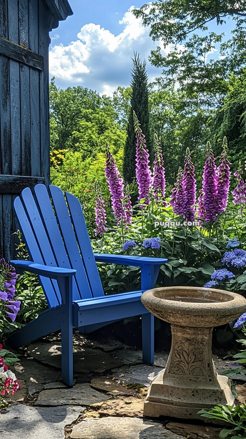 A serene garden scene featuring a blue Adirondack chair beside a birdbath, surrounded by purple foxgloves and lush greenery with a clear blue sky overhead.