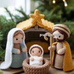 Crocheted nativity scene with figures of Mary, Joseph, and baby Jesus in a manger, all set under a star-topped stable, with festive greenery and lights in the background.
