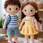 Two crocheted dolls standing side by side; one is a boy wearing a striped shirt and blue shorts, and the other is a girl in a yellow dress with pink accessories, both look cheerful with backpacks.