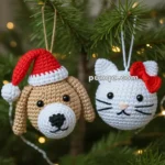 Knitted dog and cat ornaments hanging on a Christmas tree; the dog wears a red Santa hat, and the cat has a red bow.