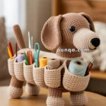 A crocheted dog-shaped organizer with pockets filled with knitting tools and yarn, standing on a wooden table in a cozy room.