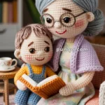 A crocheted doll of an elderly woman with gray hair and glasses sits on a sofa, reading a book with a young boy doll, who wears a yellow sweater and blue overalls.