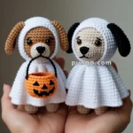 Two crocheted dog toys dressed as ghosts, one holding a small crocheted pumpkin basket, are held in hands.