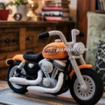 A detailed knitted motorcycle model in orange and black displayed on a wooden table, with books and a lamp in the background, creating a cozy interior setting.