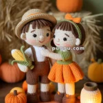 Crocheted figures of a boy and girl in autumn attire stand on a round mat with crocheted pumpkins and leaves, with a small crocheted lantern beside them. The background features more pumpkins and a stack of hay.