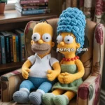 Crocheted dolls resembling cartoon characters sitting on a floral patterned chair with a stack of books nearby.