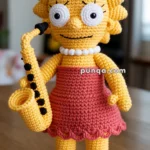 Crocheted doll resembling an animated character with yellow skin, spiky hair, a red dress, white bead necklace, and holding a yellow saxophone.