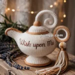 A decorative crochet teapot with the phrase "Wish upon Me" embroidered on it, placed on a wooden table with lavender sprigs, surrounded by warm fairy lights in the background.