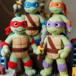 Four crocheted ninja turtle dolls, each uniquely colored with eye masks and weapons, stand on a knitted road with toy buildings around them, against a patterned background.