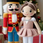 Crocheted Nutcracker and ballerina dolls standing in front of a decorated Christmas tree with lights.
