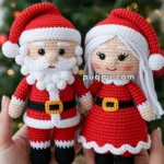 Crocheted dolls of Santa Claus and Mrs. Claus wearing red outfits with white trims, held in hands, with a Christmas tree adorned with red baubles and lights in the background.