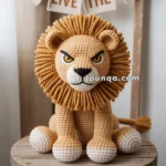 A crocheted Scar the lion with a detailed mane and expressive eyes sits on a wooden stool with a banner reading 'LONG LIVE THE KING' in the background.