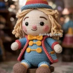 A crocheted Tweedledee doll with a colorful hat, and blue and red clothing, sitting on a wooden stool in a cozy room.