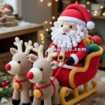 A crocheted Santa Claus figurine sits in a red sleigh filled with colorful round gifts, pulled by two crocheted reindeer with red noses, displayed on a wooden table with Christmas decorations and warm lighting in the background.